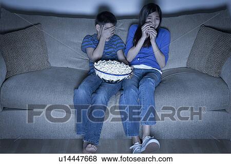 Brother and sister (10-11, 12-13) watching television View Large Photo Image Stock Photo - Brother and sister (10-11, 12-13) watching television. Fotosearch