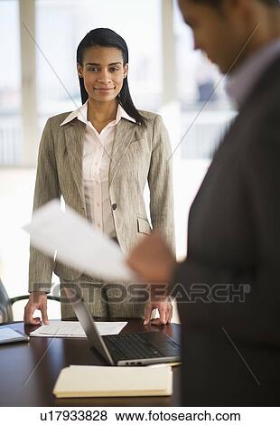 Business man and woman in office View Large Photo Image Stock Photo - Business man and woman in office. Fotosearch