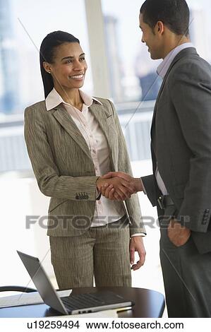 Business man and woman shaking hands View Large Photo Image Picture - Business man and woman shaking hands. Fotosearch