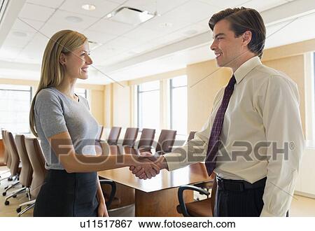 Business man and woman shaking hands View Large Photo Image Stock Photo - Business man and woman shaking hands. Fotosearch