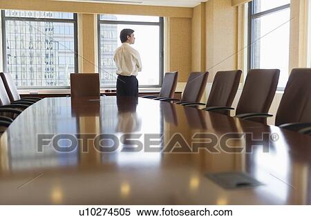 Stock Photography - Businessman standing in board room. Fotosearch