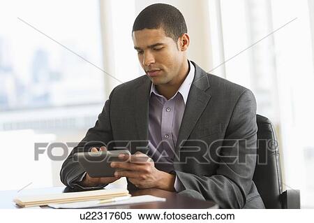Stock Photography - Businessman using tablet pc. Fotosearch