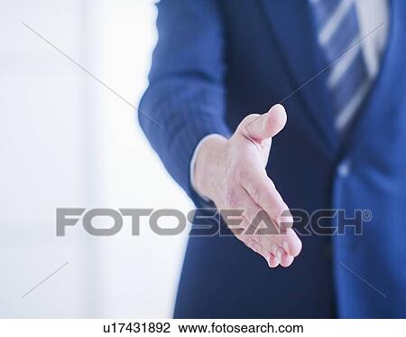 Stock Image - Businessman waiting to shake hands. Fotosearch