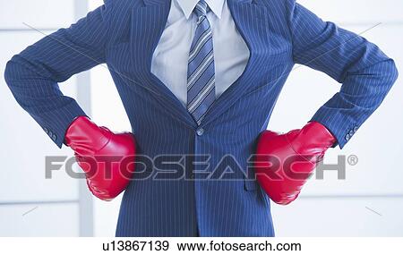 Businessman wearing red boxing gloves View Large Photo Image Stock Photo - Businessman wearing red boxing gloves. Fotosearch
