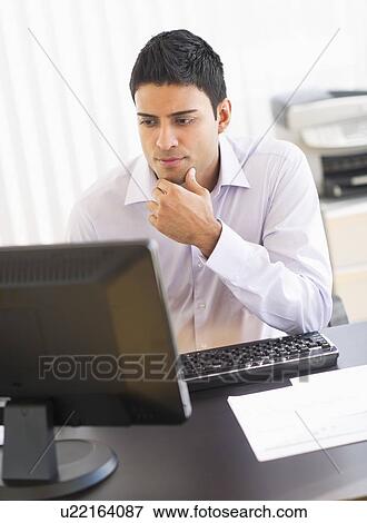 Businessman working on computer View Large Photo Image Stock Photo - Businessman working on computer. Fotosearch