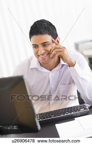 Businessman working on computer View Large Photo Image Stock Photo - Businessman working on computer. Fotosearch