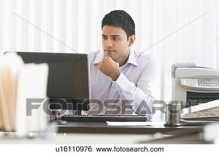 Businessman working on computer View Large Photo Image Stock Photograph - Businessman working on computer. Fotosearch