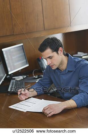 Businessman writing at desk View Large Photo Image Stock Photograph - Businessman writing at desk. Fotosearch