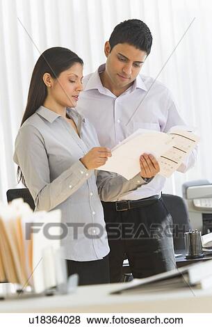 Businesswoman and businessman in office View Large Photo Image Stock Photo - Businesswoman and businessman in office. Fotosearch