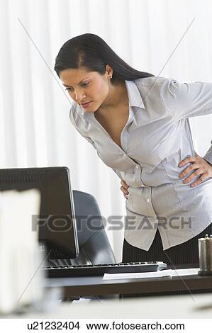 Picture - Businesswoman in office. Fotosearch