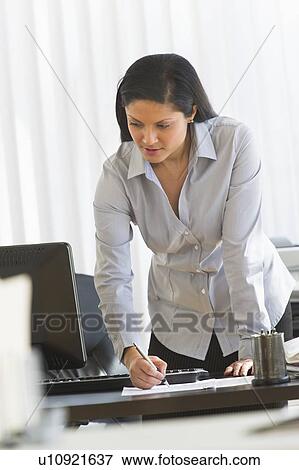 Businesswoman in office View Large Photo Image Stock Photo - Businesswoman in office. Fotosearch