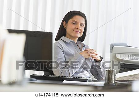 Businesswoman sitting at desk, portrait View Large Photo Image Stock Photography - Businesswoman sitting at desk, portrait. Fotosearch