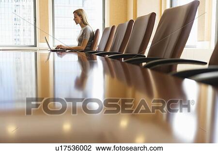 Businesswoman sitting in board room View Large Photo Image Stock Image - Businesswoman sitting in board room. Fotosearch
