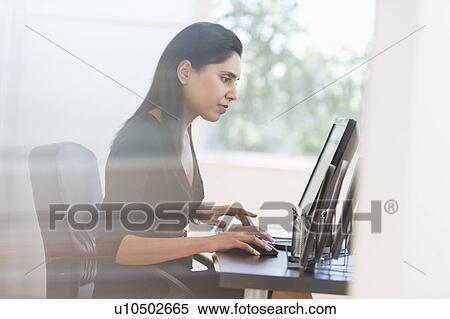 Businesswoman working on computer View Large Photo Image Stock Photography - Businesswoman working on computer. Fotosearch