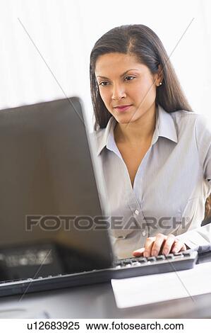 Businesswoman working on computer View Large Photo Image Stock Photography - Businesswoman working on computer. Fotosearch