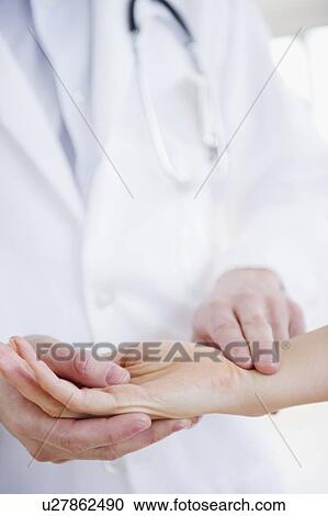 Close up of doctor taking patient's pulse View Large Photo Image Stock Image - Close up of doctor taking patient's pulse. Fotosearch