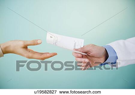 Close up of doctor's hand giving prescription to patient, studio shot View Large Photo Image Stock Photo - Close up of doctor's hand giving prescription to patient, studio shot. Fotosearch