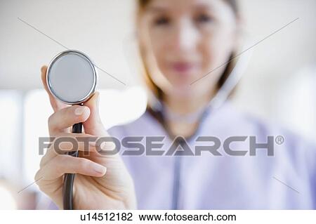 Stock Image - Close up of female doctor with stethoscope. Fotosearch