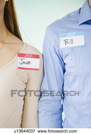 Close up of man and woman standing arm in arm, studio shot View Large Photo Image Stock Photo - Close up of man and woman standing arm in arm, studio shot. Fotosearch