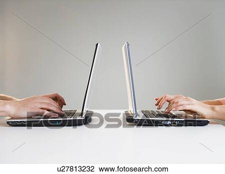 Close up of man's and woman's hands working with laptops View Large Photo Image Stock Image - Close up of man's and woman's hands working with laptops. Fotosearch