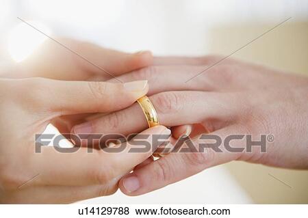 Close up of man's and woman's hands with wedding ring View Large Photo Image Stock Photo - Close up of man's and woman's hands with wedding ring. Fotosearch