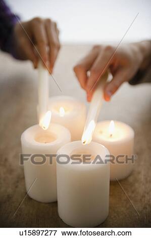 Close up of man's and woman's hands igniting candles View Large Photo Image Stock Photo - Close up of man's and woman's hands igniting candles. Fotosearch