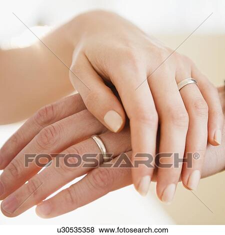 Close up of man's and woman's hands with wedding ring View Large Photo Image Stock Photo - Close up of man's and woman's hands with wedding ring. Fotosearch