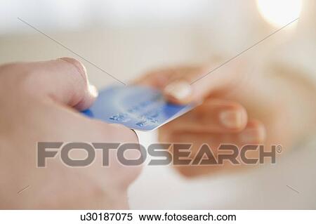 Close up of man's and woman's hands holding credit card View Large Photo Image Stock Photography - Close up of man's and woman's hands holding credit card. Fotosearch