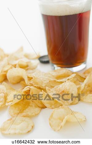 Close up of potato chips and glass of beer, studio shot View Large Photo Image Stock Image - Close up of potato chips and glass of beer, studio shot. Fotosearch