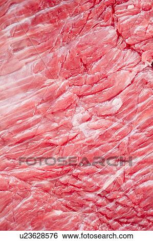 Stock Photograph - Close up of raw meat, studio shot. Fotosearch