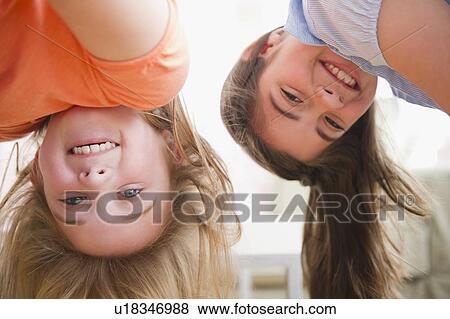 Close up of two girls upside down View Large Photo Image Stock Photo - Close up of two girls upside down. Fotosearch
