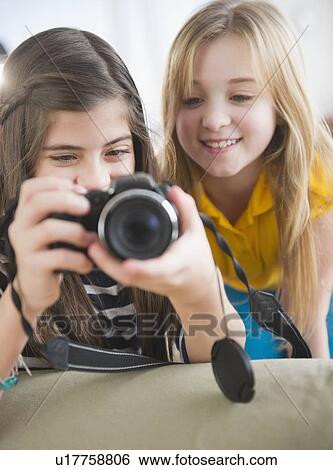 Close up of two girls using camera View Large Photo Image Stock Photograph - Close up of two girls using camera. Fotosearch