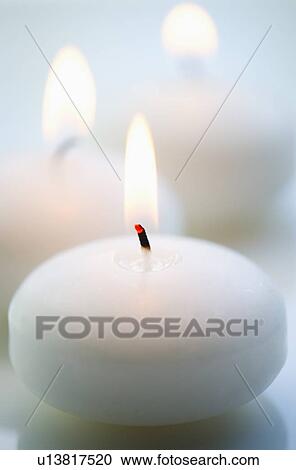 Stock Image - Close-up of white candle. Fotosearch