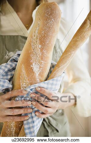 Close up of woman's hands holding baguette View Large Photo Image Stock Photography - Close up of woman's hands holding baguette. Fotosearch