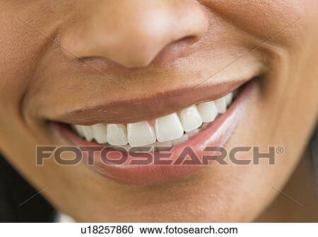 Stock Image - Close-up of woman's perfect teeth. Fotosearch