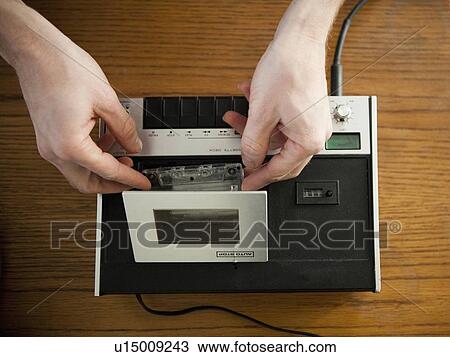Close-up view of human hands putting tape into old-fashioned tape recorder View Large Photo Image Stock Image - Close-up view of human hands putting tape into old-fashioned tape recorder. Fotosearch
