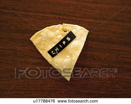 Close-up view of nacho chip with label reading chips View Large Photo Image Stock Photograph - Close-up view of nacho chip with label reading chips. Fotosearch