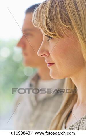Close up woman's profile with man in background View Large Photo Image Stock Photo - Close up woman's profile with man in background. Fotosearch