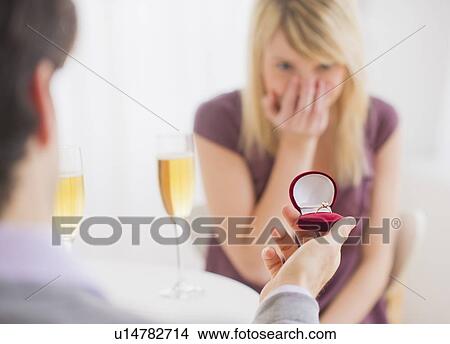 Picture - Couple celebrating engagement in restaurant. Fotosearch