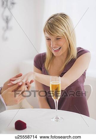 Couple celebrating engagement in restaurant View Large Photo Image Picture - Couple celebrating engagement in restaurant. Fotosearch