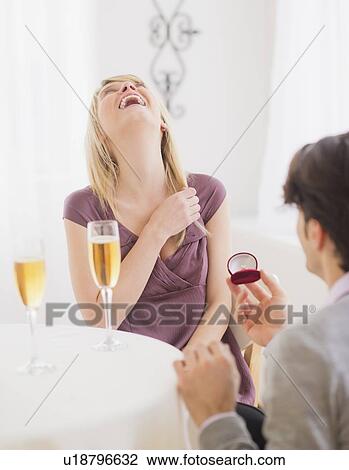 Couple celebrating engagement in restaurant View Large Photo Image Stock Image - Couple celebrating engagement in restaurant. Fotosearch