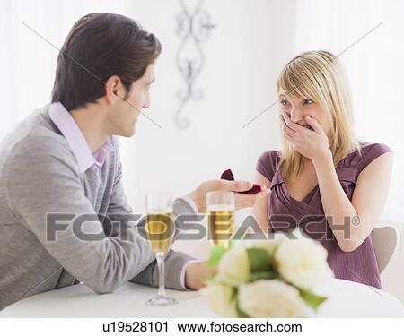Couple celebrating engagement in restaurant View Large Photo Image Stock Image - Couple celebrating engagement in restaurant. Fotosearch