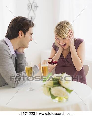 Couple celebrating engagement in restaurant View Large Photo Image Stock Image - Couple celebrating engagement in restaurant. Fotosearch