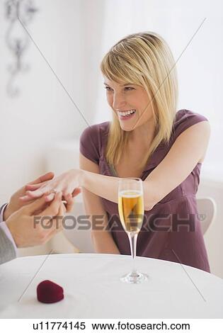 Couple celebrating engagement in restaurant View Large Photo Image Stock Photography - Couple celebrating engagement in restaurant. Fotosearch
