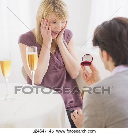 Couple celebrating engagement in restaurant View Large Photo Image Stock Photography - Couple celebrating engagement in restaurant. Fotosearch