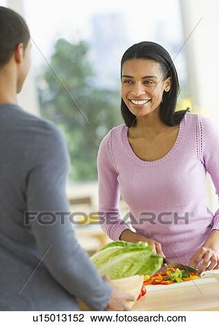 Couple chopping vegetables in kitchen View Large Photo Image Stock Image - Couple chopping vegetables in kitchen. Fotosearch