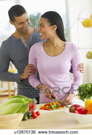 Couple chopping vegetables in kitchen View Large Photo Image Stock Photograph - Couple chopping vegetables in kitchen. Fotosearch