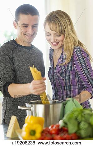 Stock Photo - Couple cooking together. Fotosearch