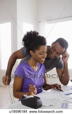 Couple doing finances together View Large Photo Image Picture - Couple doing finances together. Fotosearch