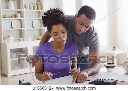 Couple doing finances together View Large Photo Image Stock Photo - Couple doing finances together. Fotosearch